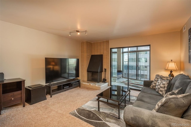 carpeted living room with a brick fireplace