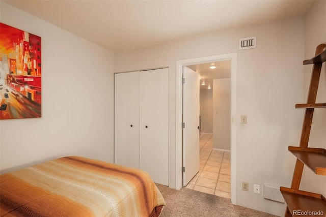 carpeted bedroom with a closet