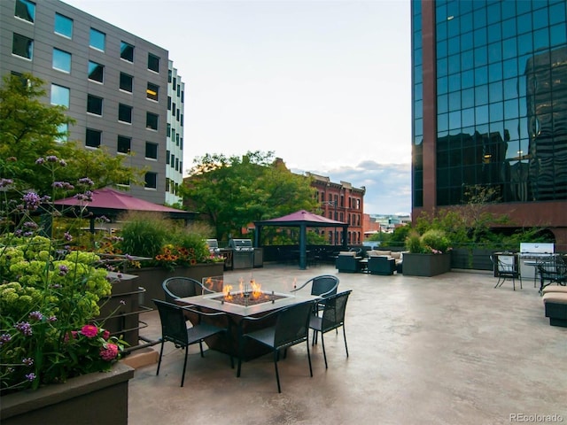 view of patio featuring a fire pit, a grill, and a gazebo