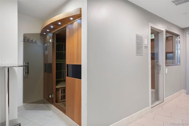 hall with light tile patterned flooring