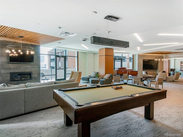 rec room with a healthy amount of sunlight, a tile fireplace, and billiards