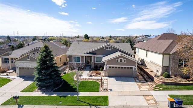 23644 E Phillips Pl, Aurora, CO 80016 - craftsman inspired home featuring stone siding, driveway, a residential view, and a front yard