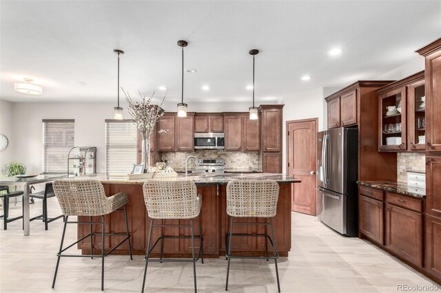 23644 E Phillips Pl, Aurora, CO 80016 - kitchen with a sink, stainless steel appliances, backsplash, and a breakfast bar