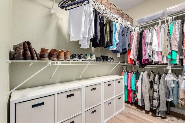 walk in closet featuring light wood-style flooring