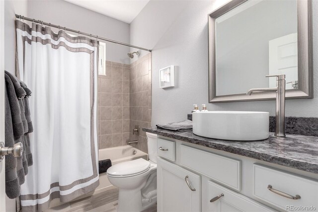 23644 E Phillips Pl, Aurora, CO 80016 - full bathroom featuring toilet, shower / tub combo with curtain, vanity, and wood finished floors