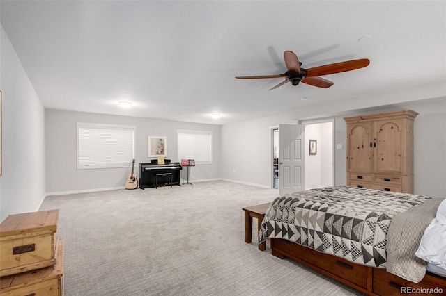 bedroom featuring baseboards, light carpet, and ceiling fan