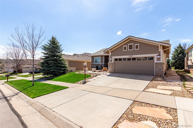 craftsman inspired home with an attached garage, a front lawn, brick siding, and driveway