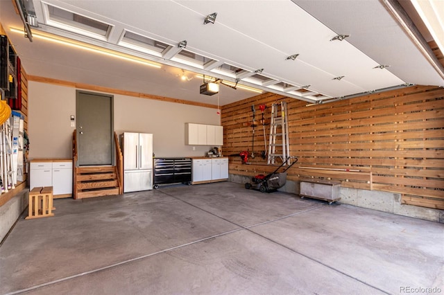 garage with a workshop area and a garage door opener