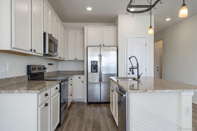 kitchen featuring white cabinets, stainless steel appliances, dark wood-type flooring, and a sink