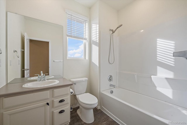 bathroom with shower / washtub combination, toilet, and vanity