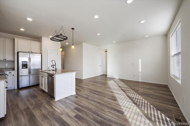 kitchen with a sink, appliances with stainless steel finishes, recessed lighting, and dark wood-style flooring