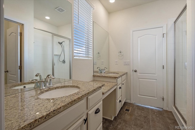 full bathroom featuring a stall shower, visible vents, and a sink