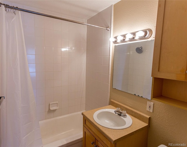2500 S York St Unit 213, Denver, CO 80210 - full bath with vanity, shower / bath combo with shower curtain, and a textured wall