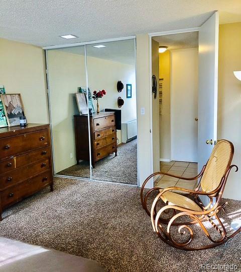 2500 S York St Unit 213, Denver, CO 80210 - bedroom featuring a textured ceiling and a closet