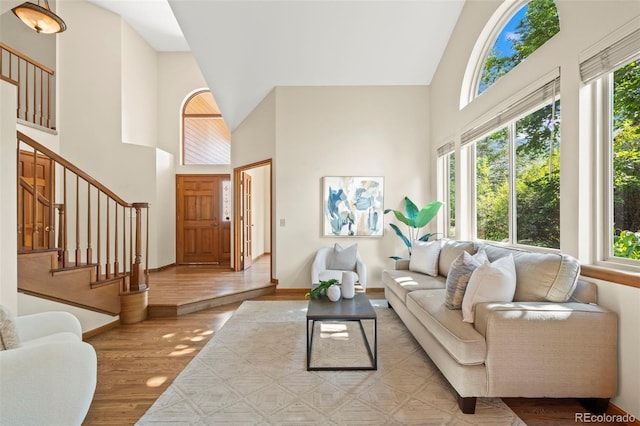 7313 Poston Way, Boulder, CO 80301 - living area featuring a towering ceiling, plenty of natural light, wood finished floors, and stairway
