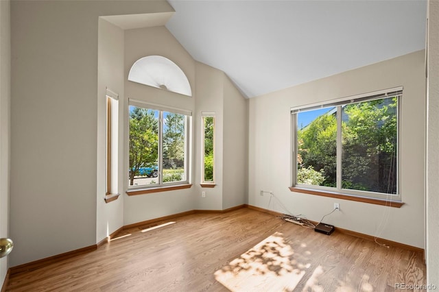 7313 Poston Way, Boulder, CO 80301 - spare room featuring wood finished floors and high vaulted ceiling