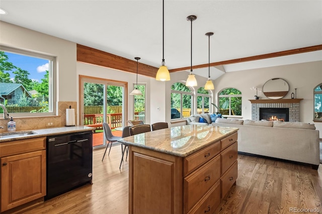 7313 Poston Way, Boulder, CO 80301 - kitchen with black dishwasher, light wood-style flooring, beam ceiling, light stone countertops, and decorative backsplash