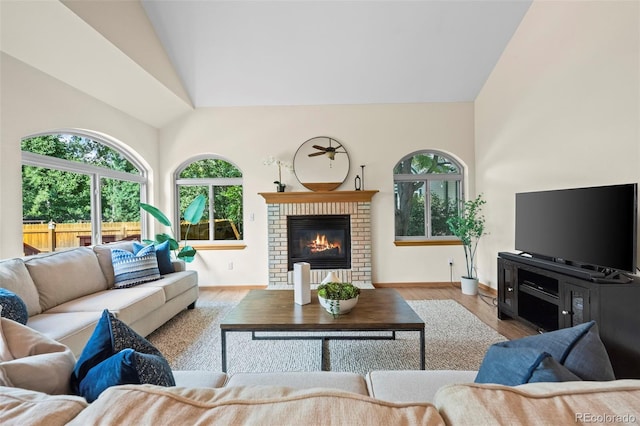 7313 Poston Way, Boulder, CO 80301 - living area with plenty of natural light, wood finished floors, high vaulted ceiling, and a fireplace