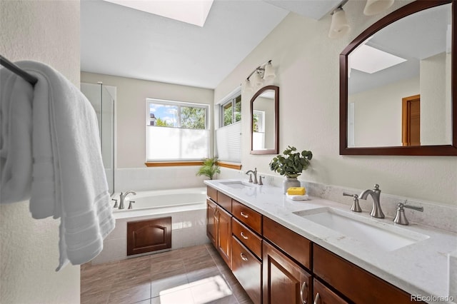 7313 Poston Way, Boulder, CO 80301 - bathroom featuring a bath, double vanity, tile patterned flooring, and a skylight