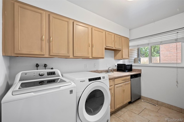 laundry room featuring laundry area, light tile patterned flooring, a sink, and washer and clothes dryer