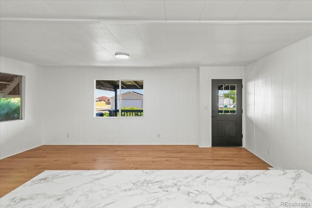 entryway with wood walls and hardwood / wood-style floors