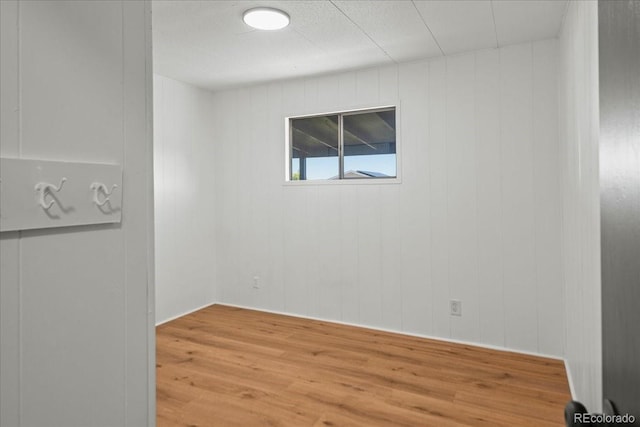 unfurnished room with hardwood / wood-style flooring