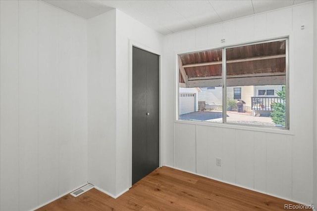 spare room with wood-type flooring