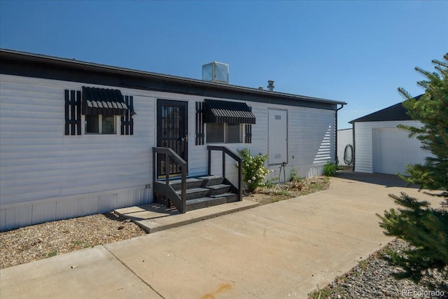 view of front facade featuring an outbuilding and a garage