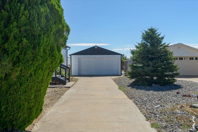 view of front facade featuring a garage and an outdoor structure