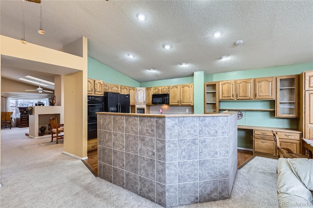 kitchen featuring lofted ceiling, a kitchen island, ceiling fan, black appliances, and light carpet