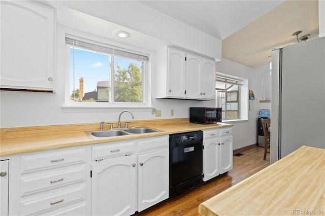 3907 E 133rd Ct, Thornton, CO 80241 - kitchen featuring black appliances, a sink, wood finished floors, and white cabinets
