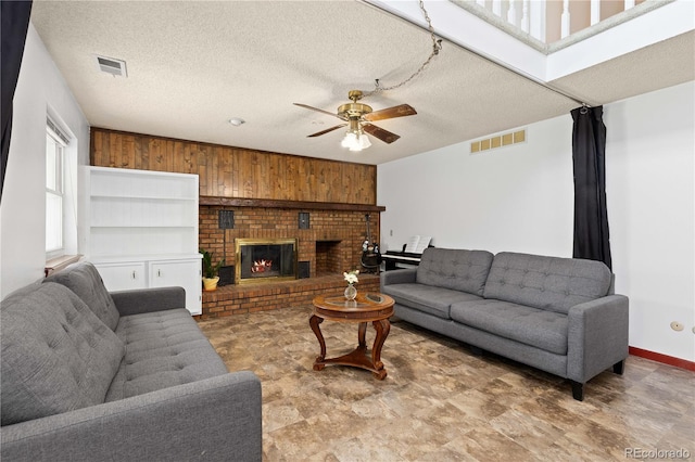 3907 E 133rd Ct, Thornton, CO 80241 - living room with a ceiling fan, stone finish floors, a fireplace, and a textured ceiling
