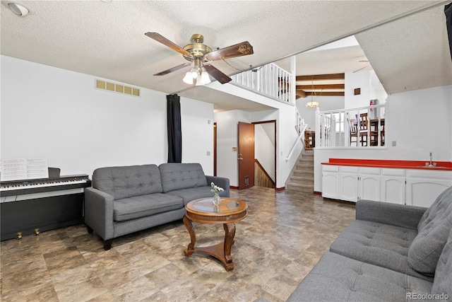 3907 E 133rd Ct, Thornton, CO 80241 - living area with stairway, ceiling fan, and a textured ceiling