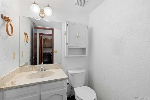 3907 E 133rd Ct, Thornton, CO 80241 - half bathroom featuring vanity, toilet, and a textured wall