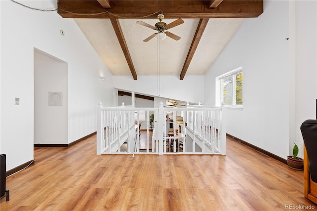 3907 E 133rd Ct, Thornton, CO 80241 - hallway with an upstairs landing, wood finished floors, beam ceiling, baseboards, and high vaulted ceiling