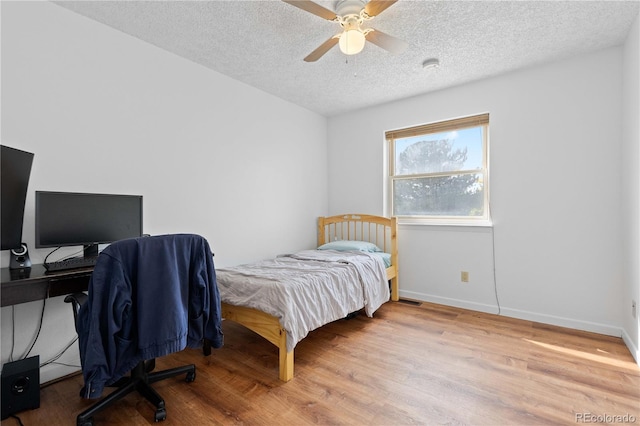 3907 E 133rd Ct, Thornton, CO 80241 - bedroom with wood finished floors, a textured ceiling, baseboards, and a ceiling fan
