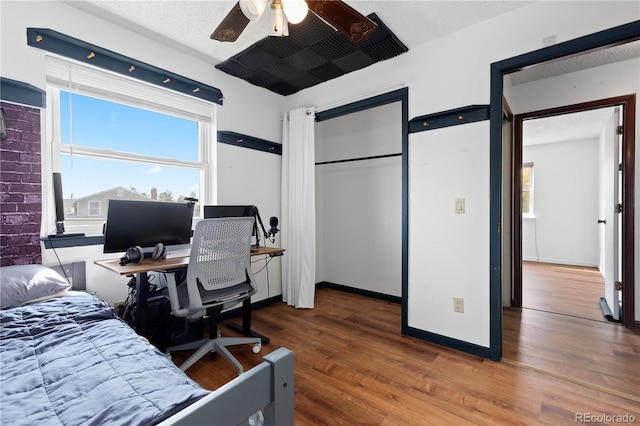 3907 E 133rd Ct, Thornton, CO 80241 - bedroom with multiple windows, wood finished floors, ceiling fan, and baseboards