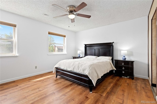 3907 E 133rd Ct, Thornton, CO 80241 - bedroom featuring wood finished floors, baseboards, a textured ceiling, and ceiling fan