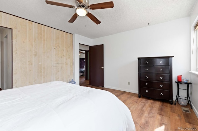 3907 E 133rd Ct, Thornton, CO 80241 - bedroom with wood finished floors, baseboards, a textured ceiling, and ceiling fan