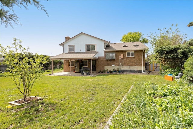 3907 E 133rd Ct, Thornton, CO 80241 - rear view of property featuring a patio area, brick siding, a yard, and a chimney