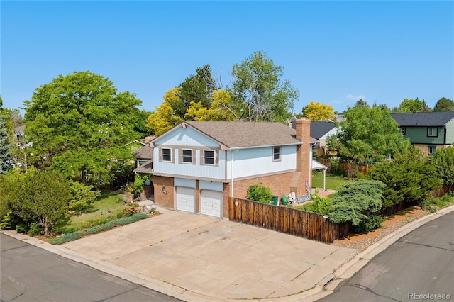 3907 E 133rd Ct, Thornton, CO 80241 - view of front of home with a garage, a chimney, concrete driveway, and brick siding