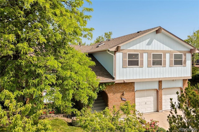 3907 E 133rd Ct, Thornton, CO 80241 - view of front of house featuring roof with shingles, an attached garage, brick siding, and concrete driveway
