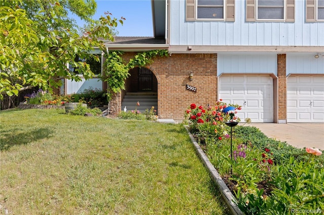 3907 E 133rd Ct, Thornton, CO 80241 - entrance to property featuring brick siding, a garage, a yard, and concrete driveway
