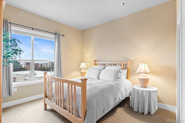 carpeted bedroom featuring baseboards