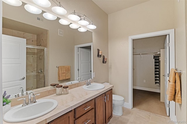 bathroom featuring a sink, visible vents, double vanity, and a shower stall