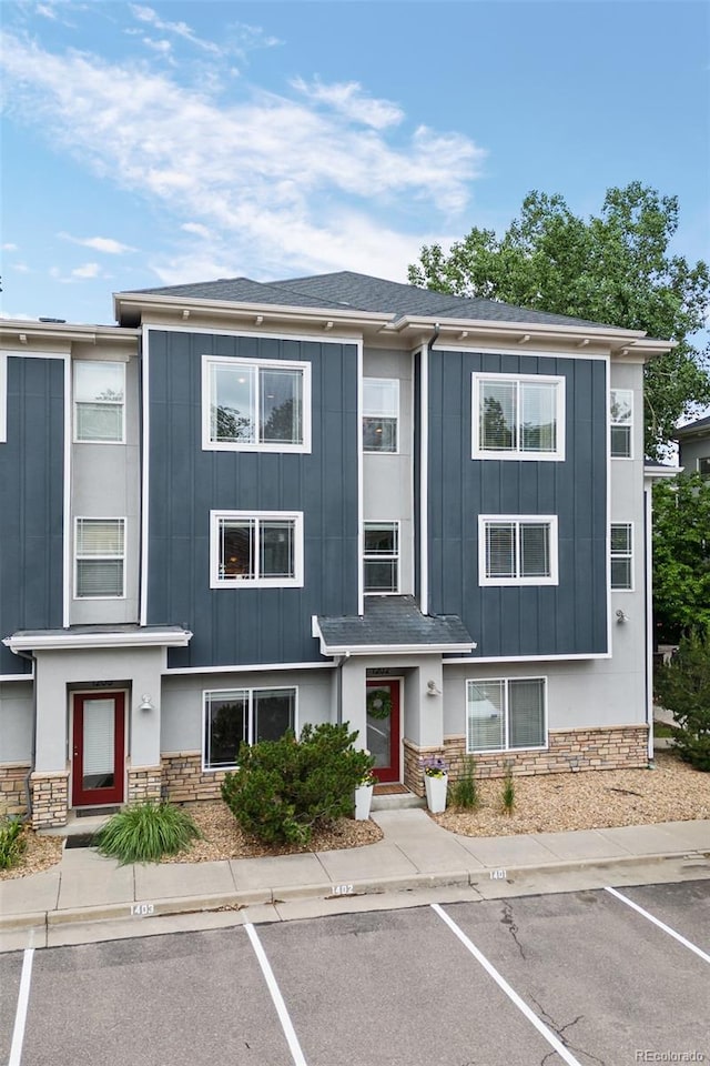 9300 E Florida Ave Unit 1202, Denver, CO 80247 - multi unit property with stone siding, board and batten siding, and uncovered parking
