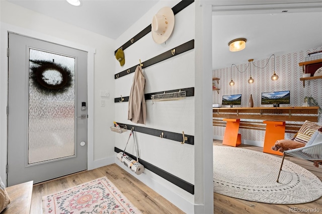 9300 E Florida Ave Unit 1202, Denver, CO 80247 - foyer entrance featuring wood finished floors, wallpapered walls, and an accent wall