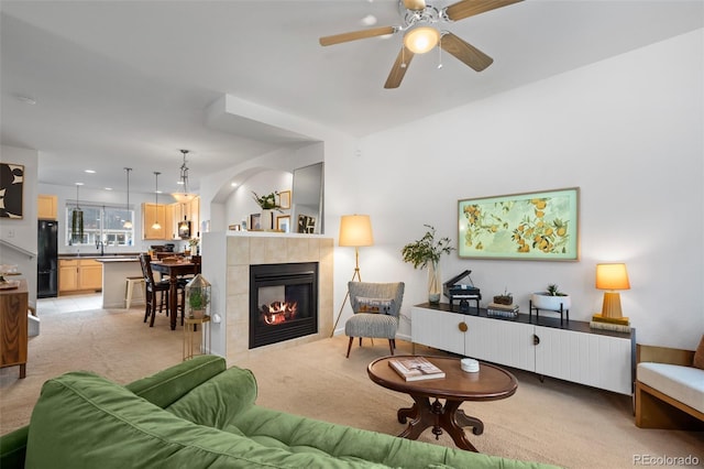 9300 E Florida Ave Unit 1202, Denver, CO 80247 - living room with light colored carpet, a ceiling fan, and a tiled fireplace