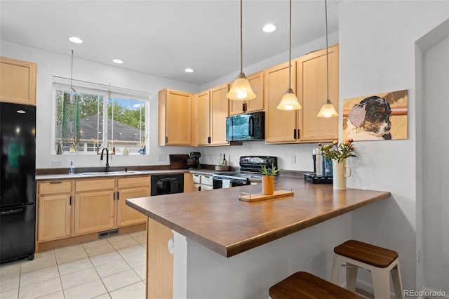 9300 E Florida Ave Unit 1202, Denver, CO 80247 - kitchen featuring black appliances, light brown cabinetry, dark countertops, a peninsula, and light tile patterned floors