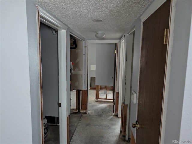220 Mckinley Dr, Bennett, CO 80102 - hallway with a textured ceiling and unfinished concrete floors